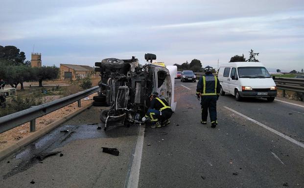 Los servicios de emergencias atienden a los ocupantes del camión tras el accidente. /112RM