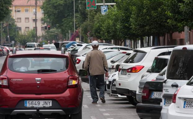 Un gorrilla camina junto a unos coches aparcados en Murcia. /Juan Carlos Caval / AGM
