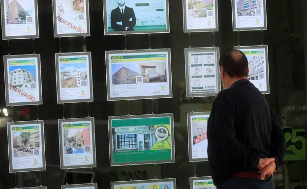 A man looks at a real estate window in a file photo.