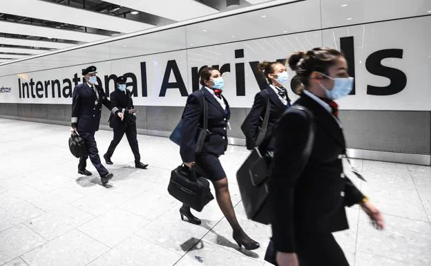The crew of a plane walks through one of the terminals at London Heathrow Airport.