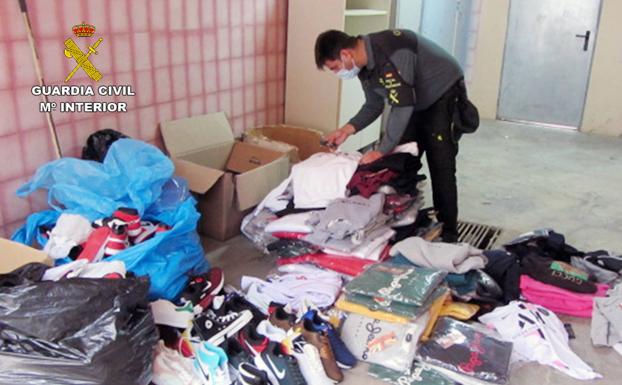 An agent inspects the seized garments. 