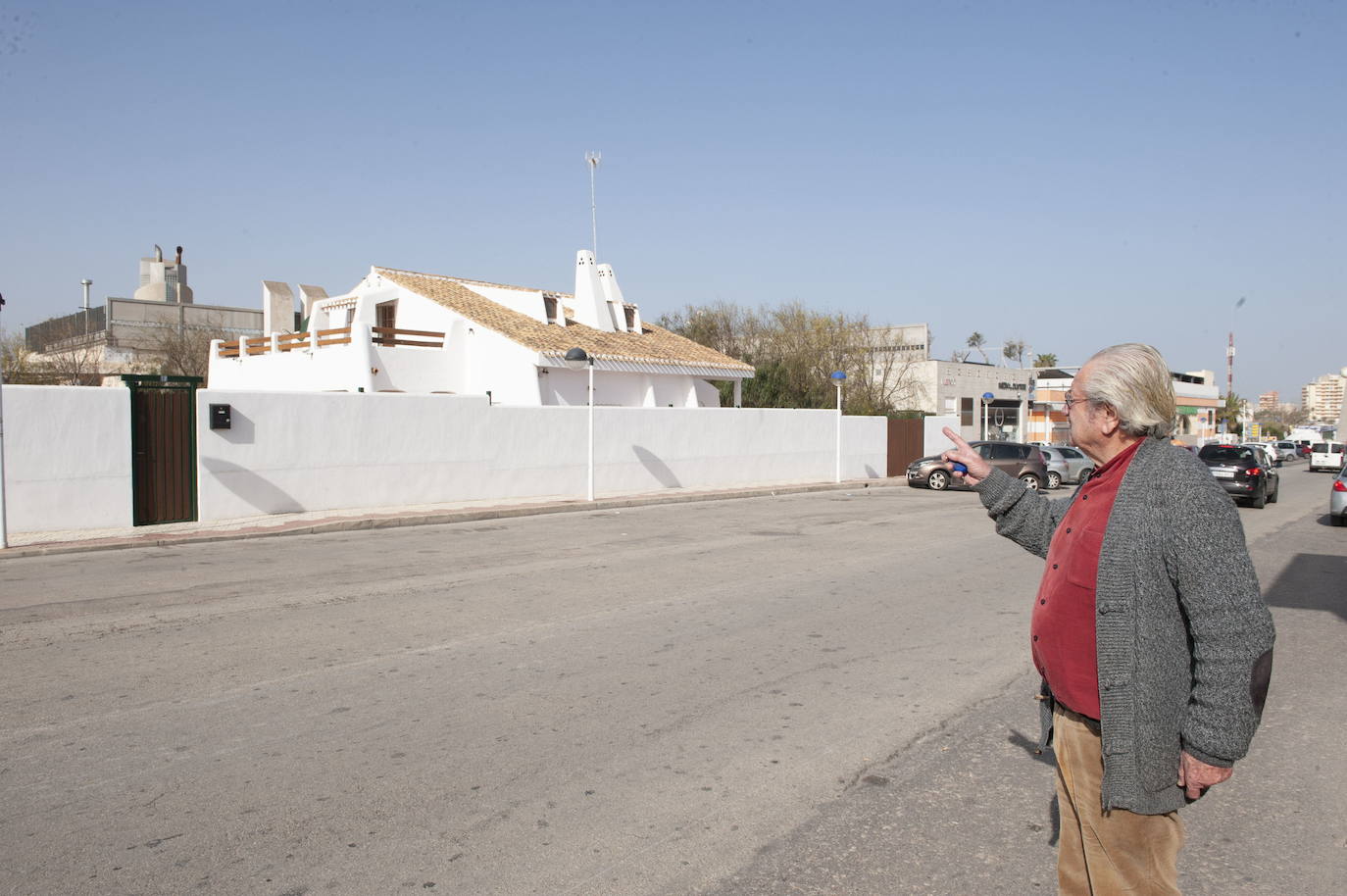 Diego Martínez points to his home, with the bar facilities behind it, in a file photo.