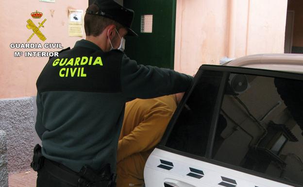 An agent of the Civil Guard with the detainee.