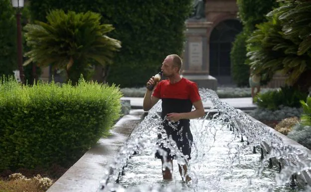 A man cooling off in a fountain during the heat wave last July. 