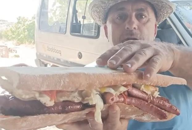 Ginés 'Corregüela' displays one of his giant sandwiches.