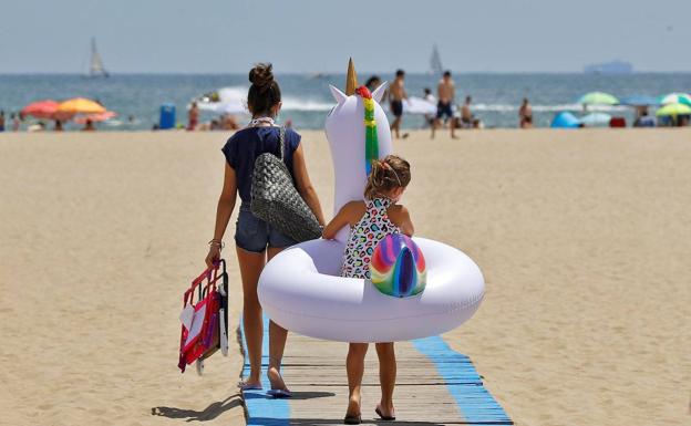 A girl with a unicorn float on the beach, in a file image. 