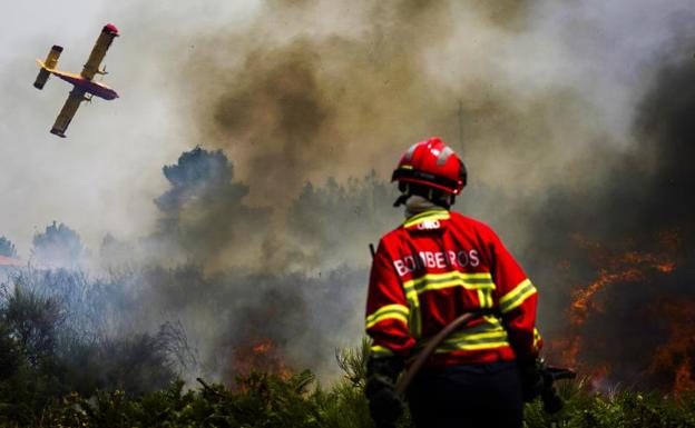 A Portuguese firefighter tries to contain the flames. 