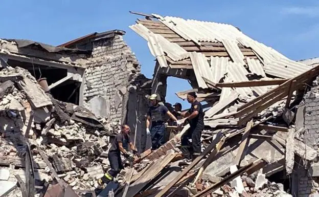 Rescue forces work in the ruins of a bombed-out building in Donetsk. 