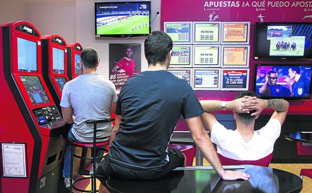 Young people spend their time in a bookmaker, in a file image. 