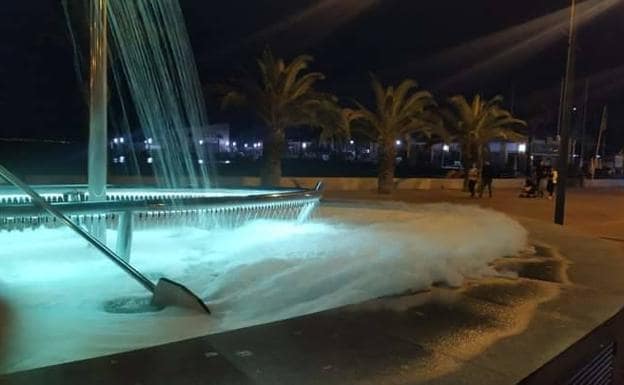 The foam overflows the pond of the promenade fountain.