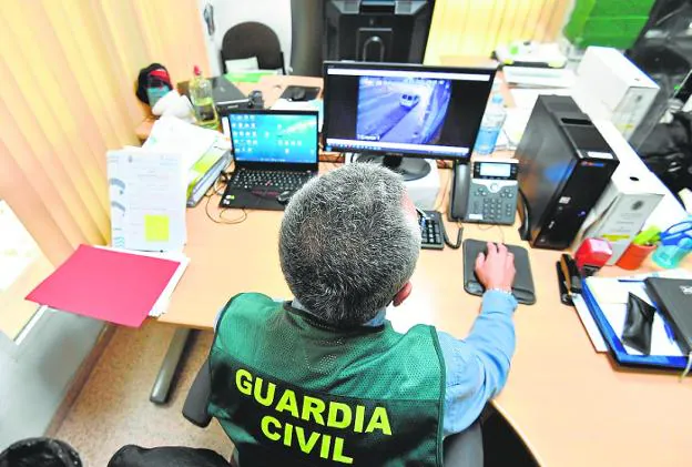 The head of the GIAT group of the Civil Guard of the Region reviews a video in his office. 