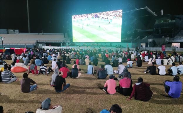 Workers during the England-Senegal match, in a cricket stadium that serves as their 'fan zone' in an industrial suburb of Doha. 