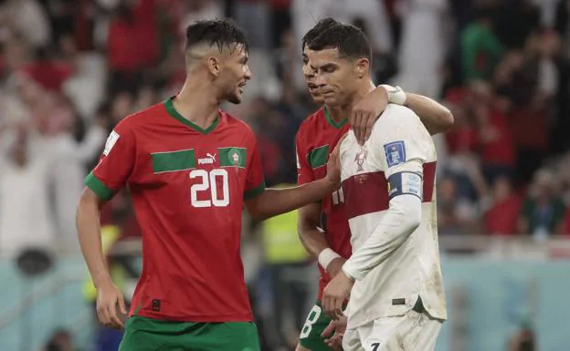 Ronaldo, comforted by Moroccan soccer players after the match.