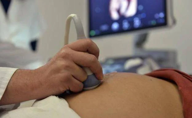 A doctor performs an ultrasound on a pregnant woman, in a file image. 