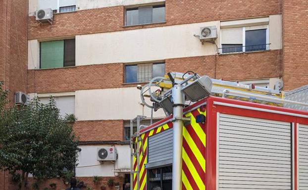 Fire truck in front of the building where the fire started.